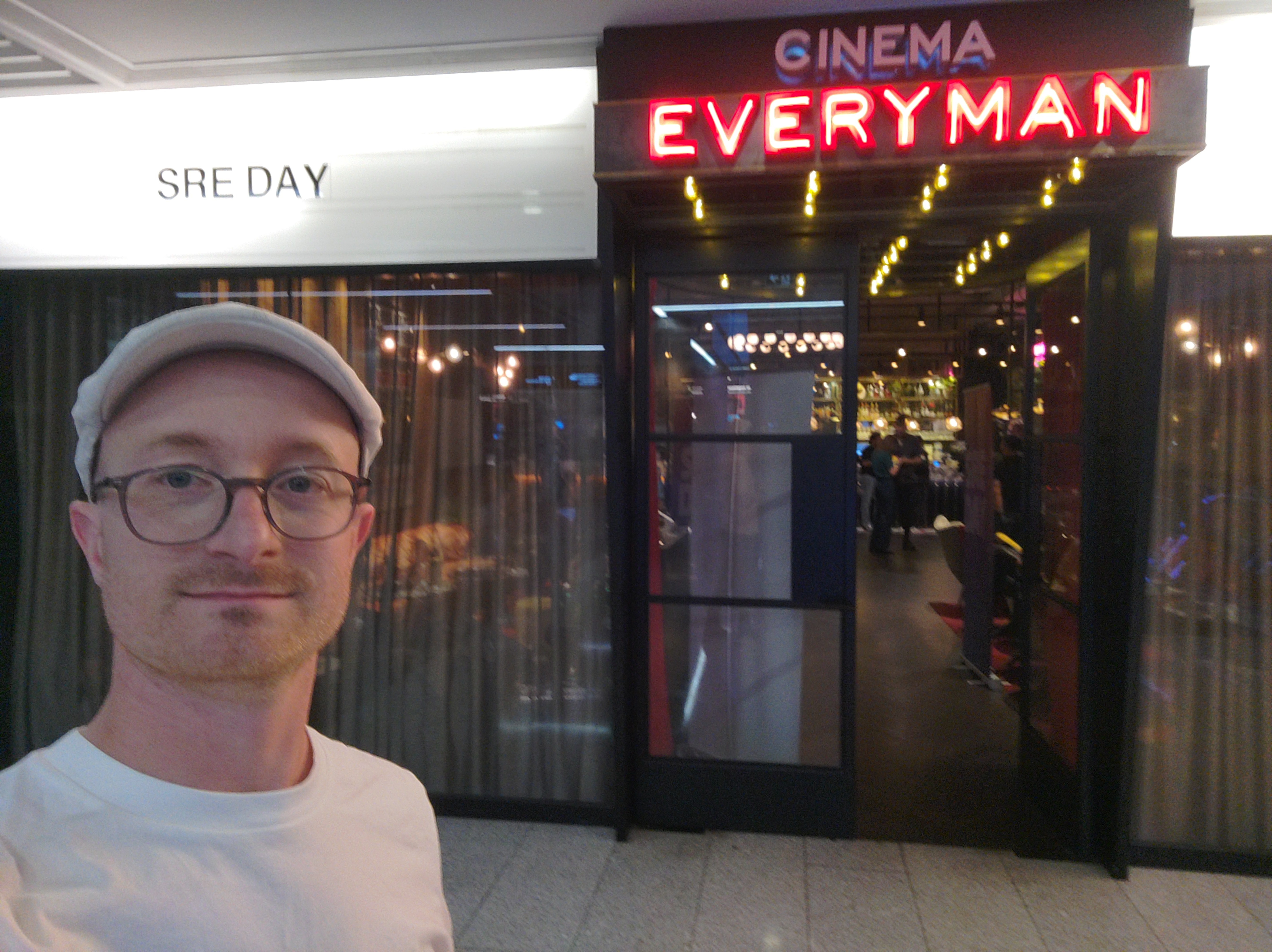 Louis Fradin outside the Everyman Cinema in Canary Wharf, under the "SRE DAY" sign, before the talk.